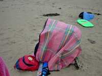 Our improvised shelter:  There are three of us and a dog under there!