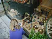 Juli *buying* the products in the window with a camera